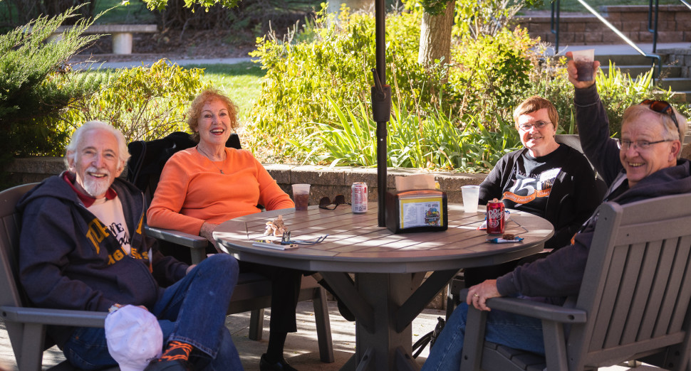 Alumni having a conversation on a patio