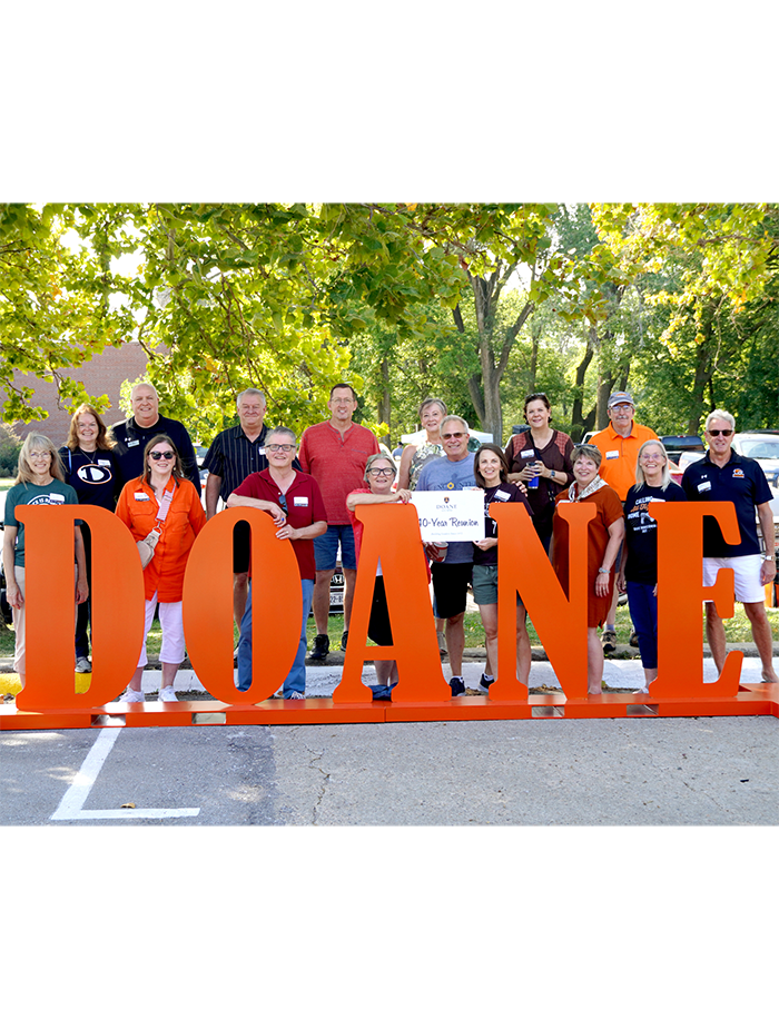 Alumni holding Doane sign