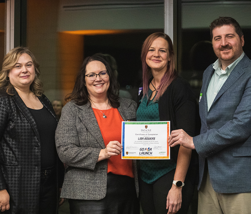 Doane students holding certificate