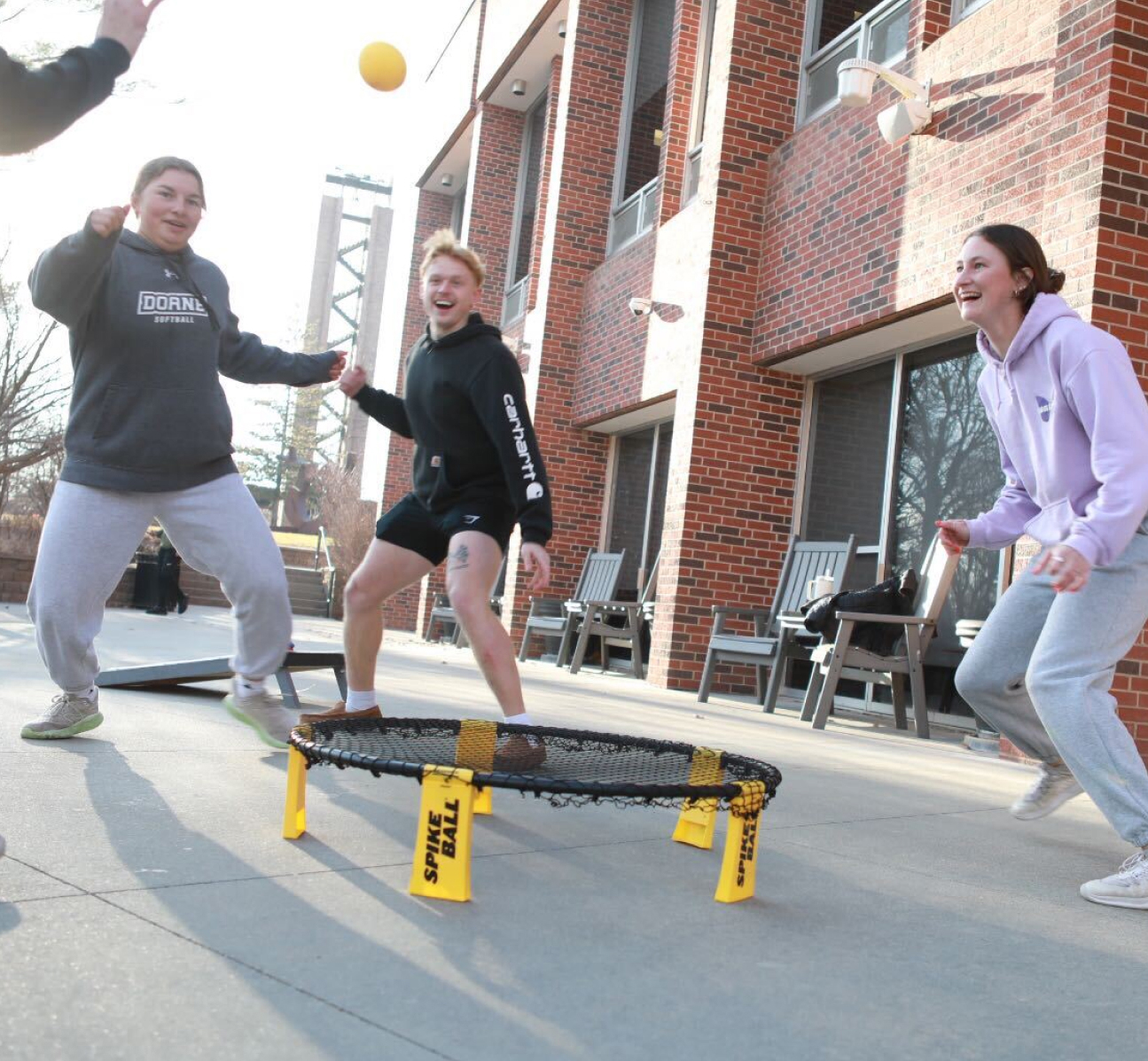 Doane student playing outside of a residence hall