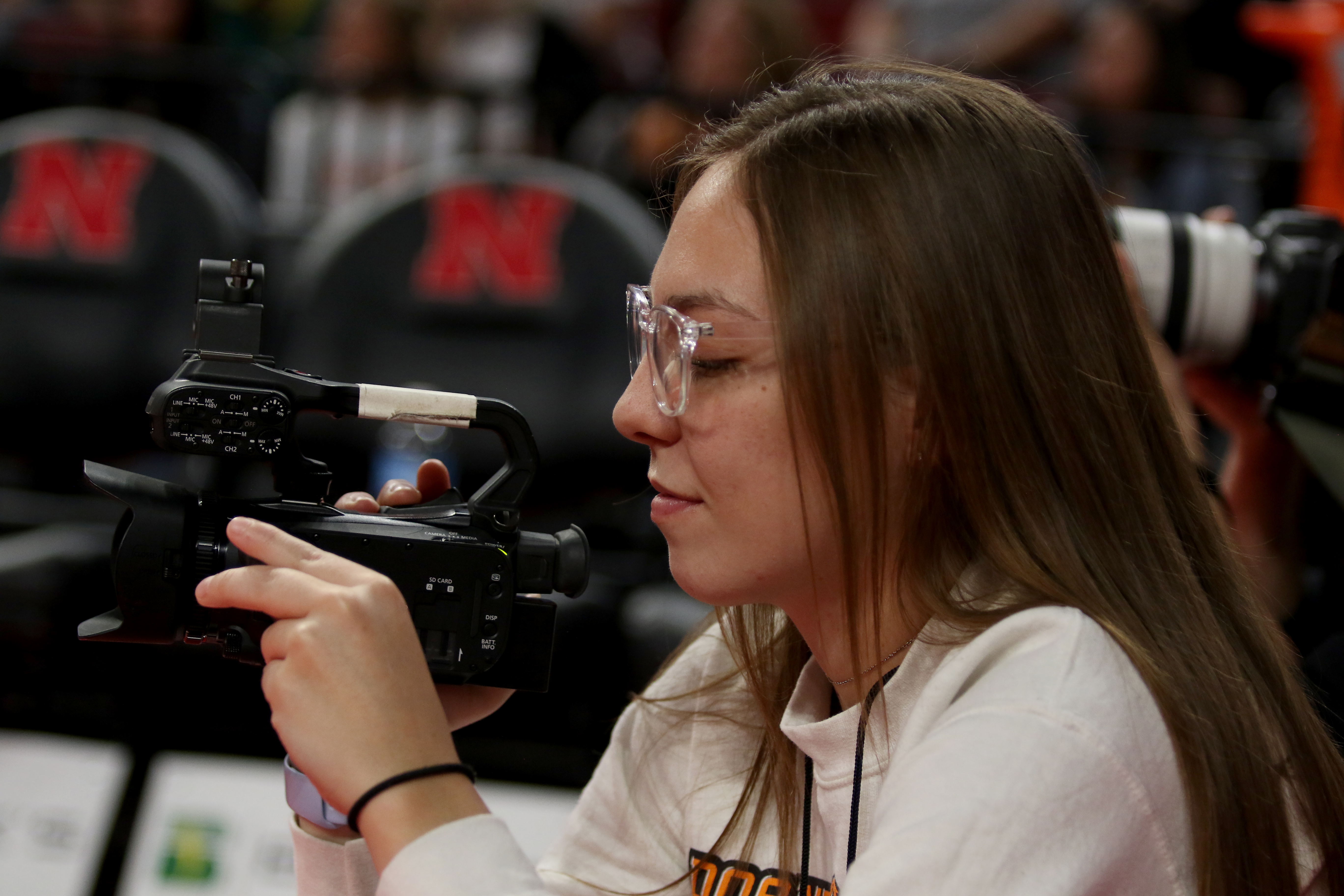 Anna Beckett takes video for Doane Athletics