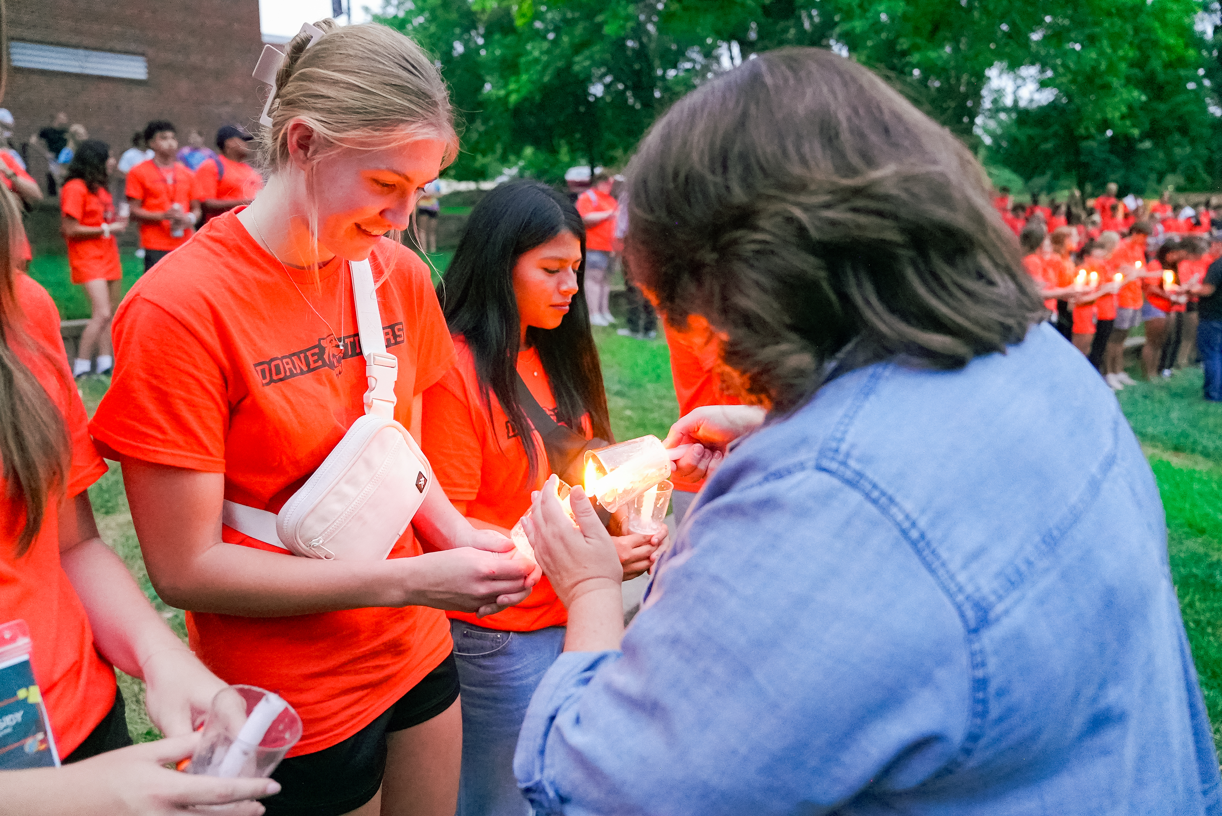 Kim Jarvis lights a student's candle