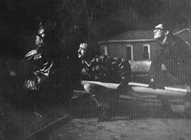 Unidentified men (students perhaps) help a firefighter with a hose the night of Feb. 28, 1969. 