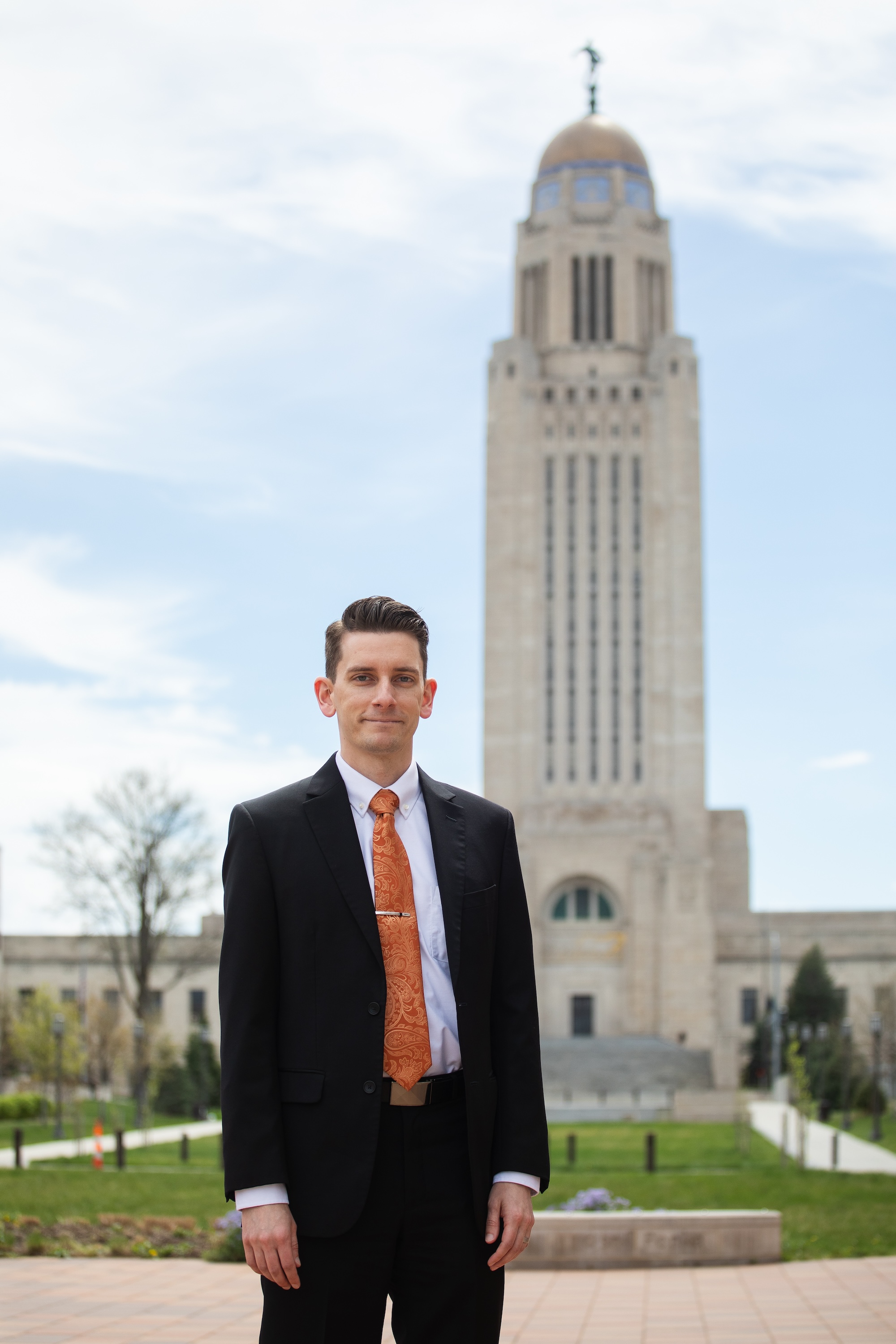 Zach Blackman ’09 stands in front of the Nebraska state Capitol Building