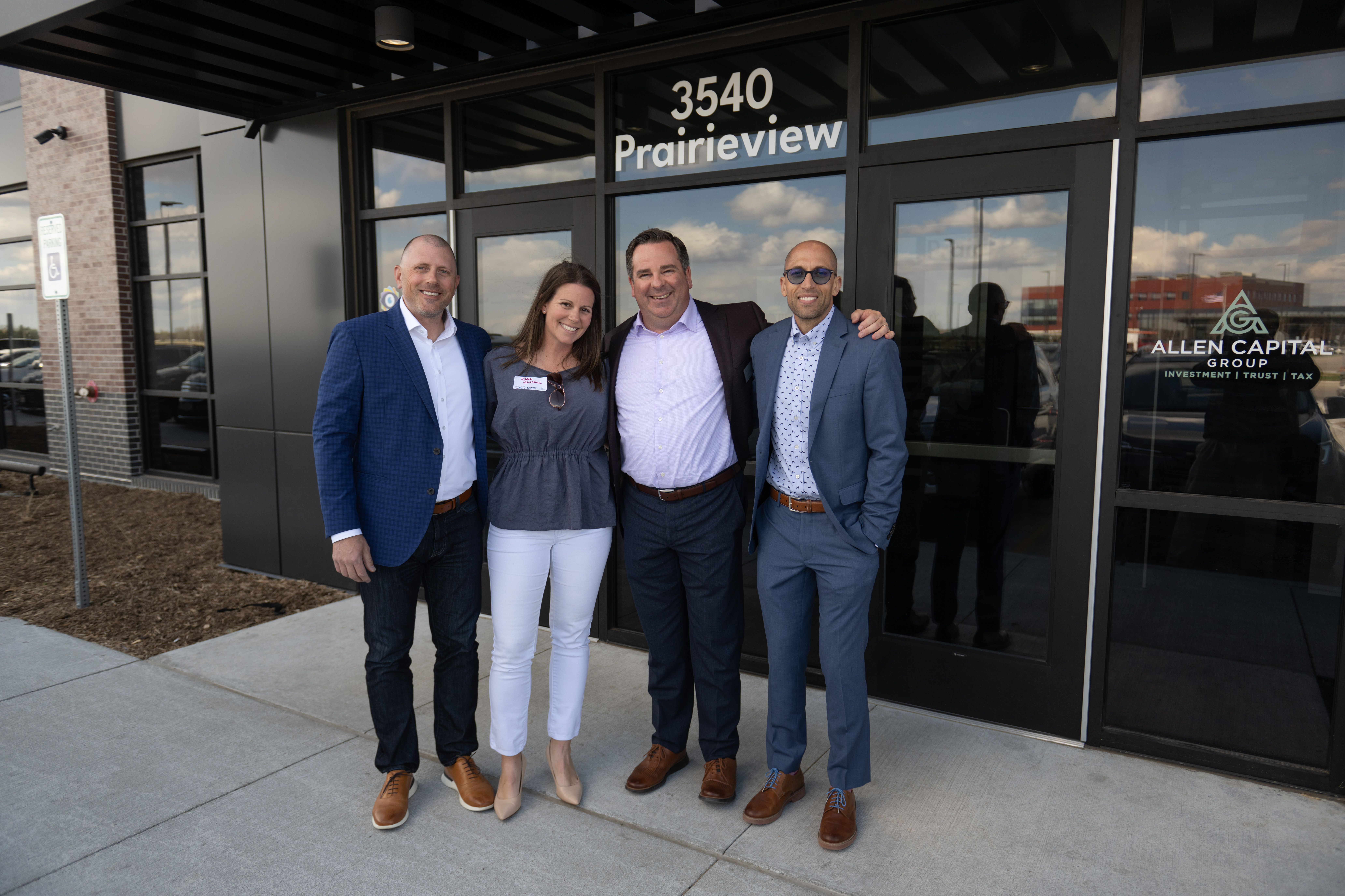 Friends and classmates Chad Hudnall O.D., Kara Hudnall, Mark Allen and Josh Conner O.D. stand together for a photo outside their businesses' new, two-story facility.