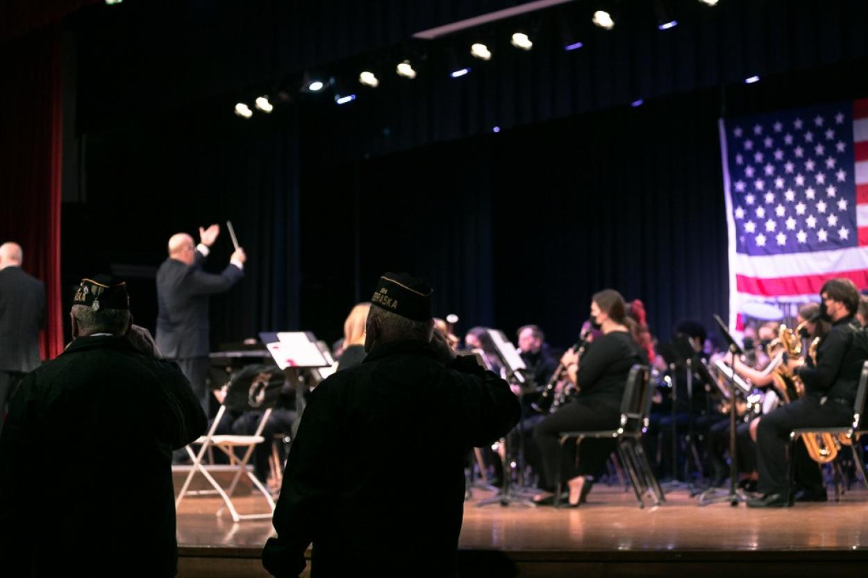 Veterans stand at attention as the Doane University Band plays for Veterans Day