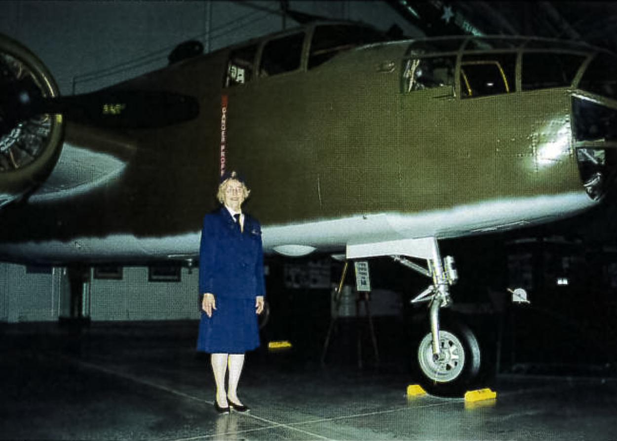 Lois Boien Durham ’43 standing in front of a B-25 airplane