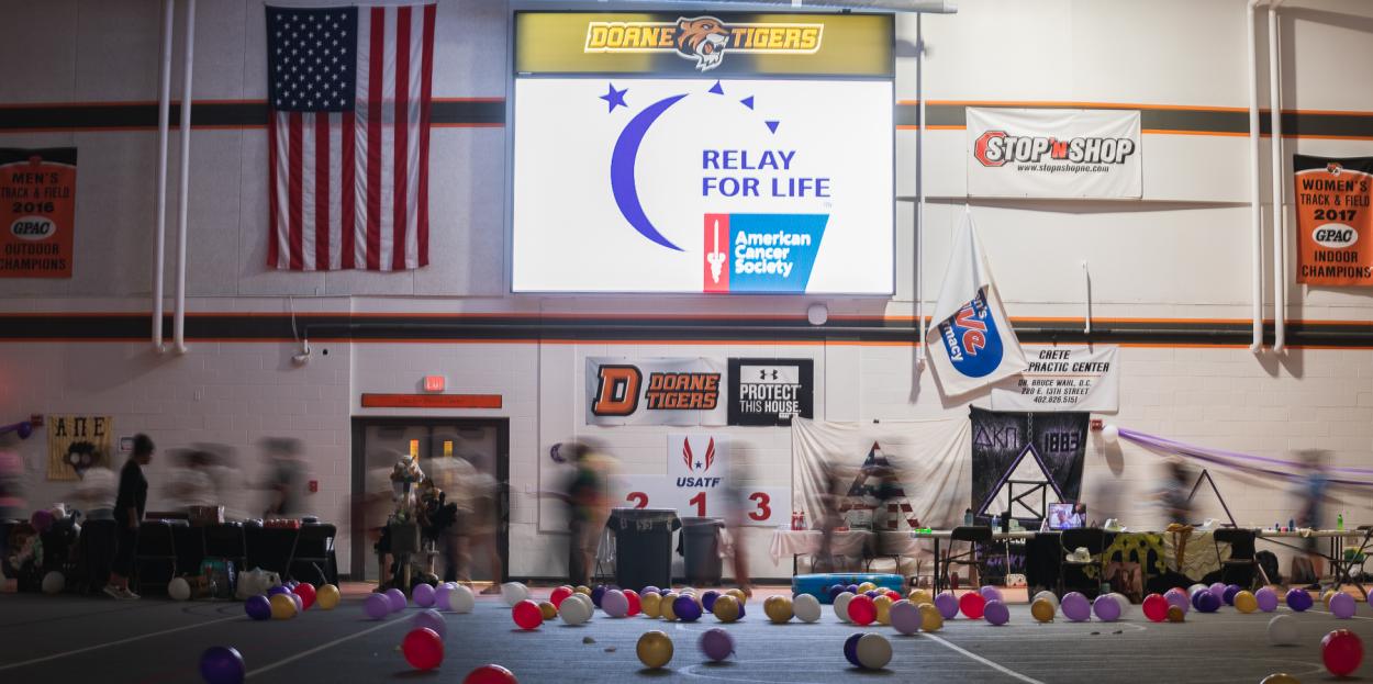 Doane students, faculty and staff as well as Crete residents walk around the indoor track in Fuhrer Fieldhouse for Relay for Life. 