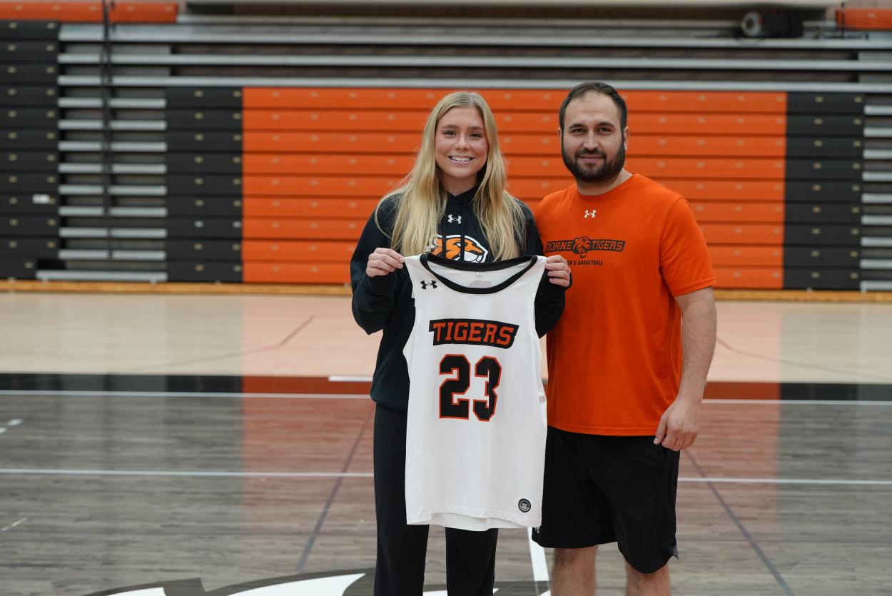 Mak Hatcliff and head women's basketball coach Ryan Baumgartner stand in Haddix