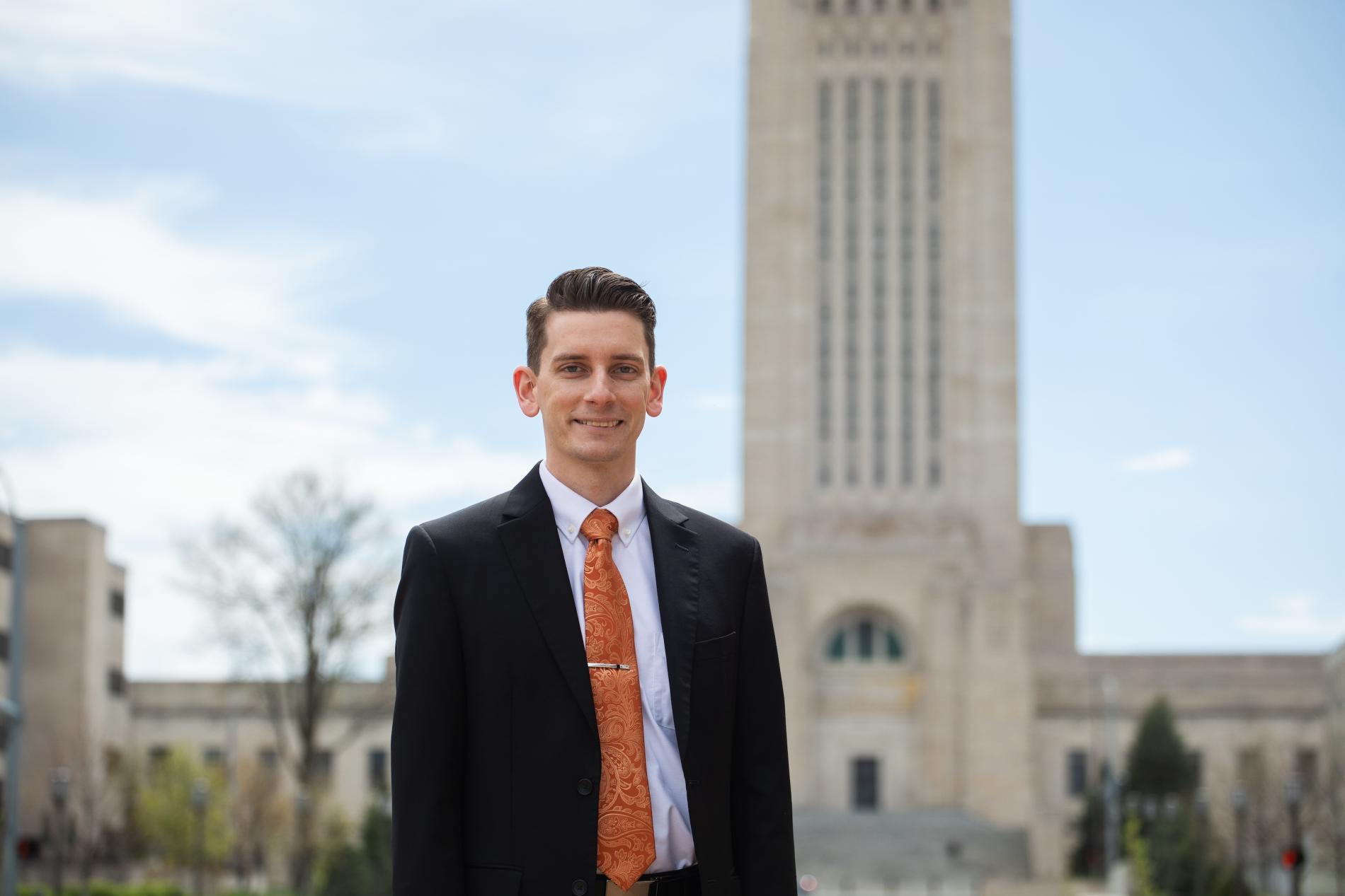 Zach Blackman ’09 stands in front of the Nebraska Capitol Building