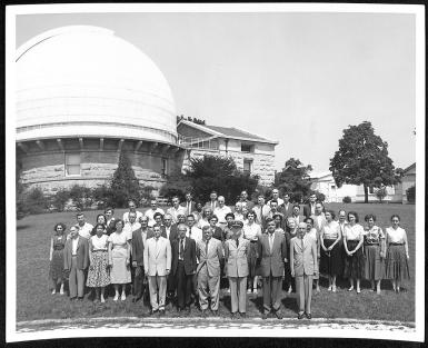 Employees of the U.S. Naval Observatory stand posed in front of one of the transit buildings