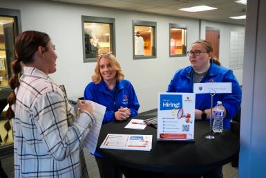 A student talks to two employers at Doane University’s Employer Connections Event 