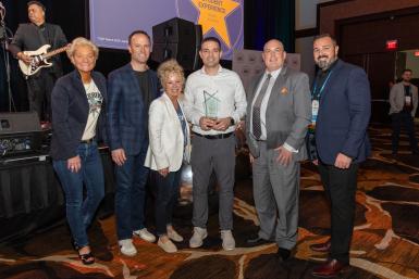 Members of Doane's technology team hold their award at the Transact conference